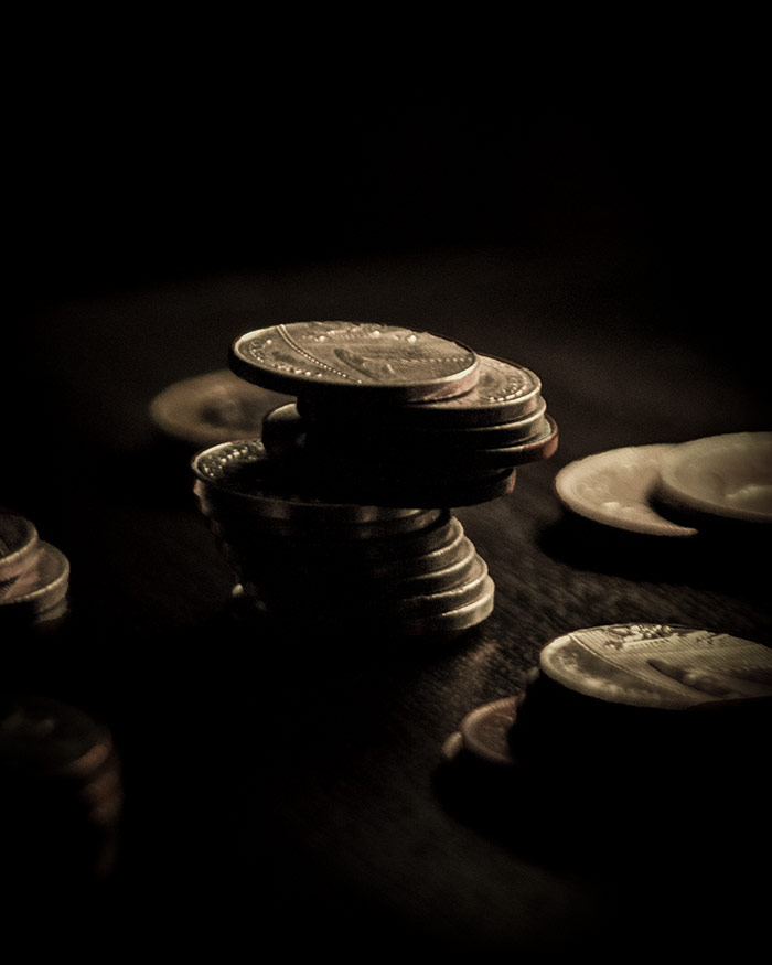 coins on a surface in the dark