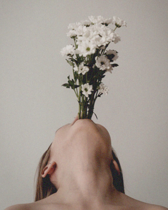 a woman speaks self-love affirmations that bloom as flowers