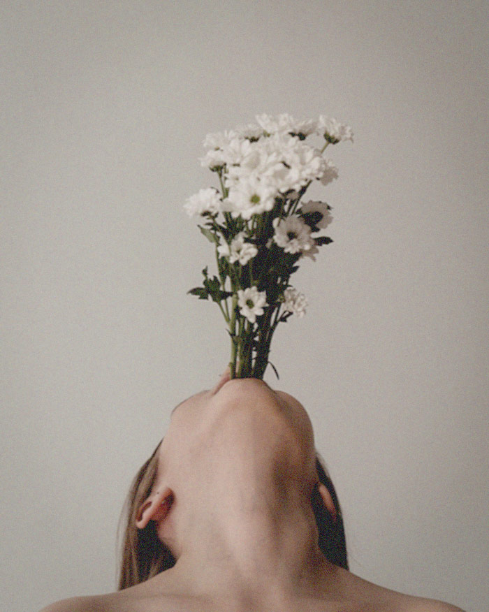 a woman speaks self-love affirmations that bloom as flowers