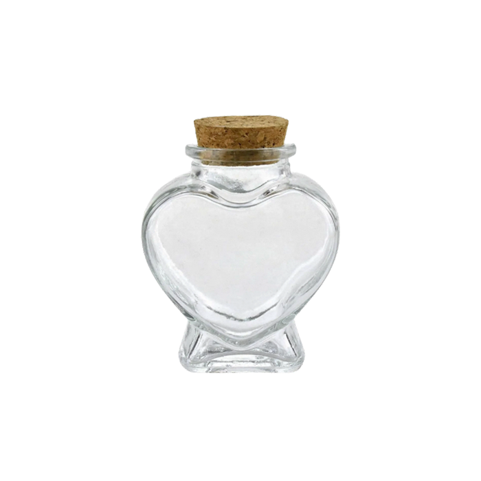 a small heart shaped glass jar with cork lid