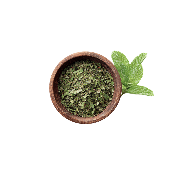 dried mint leaves in a wood bowl with a mint leaf around it