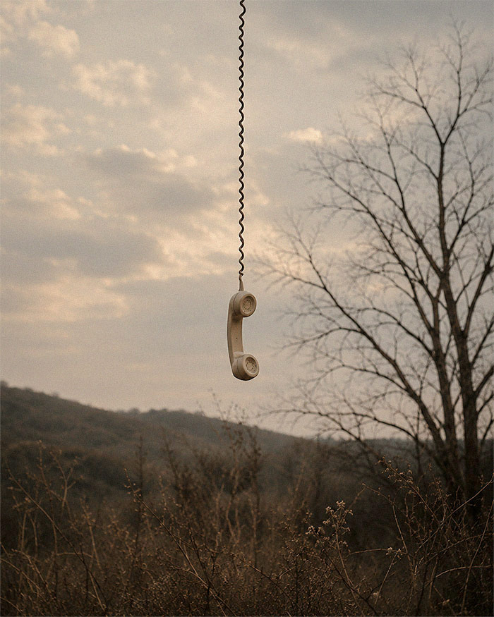 a phone hangs from the sky in a field to fulfill the job application response spell