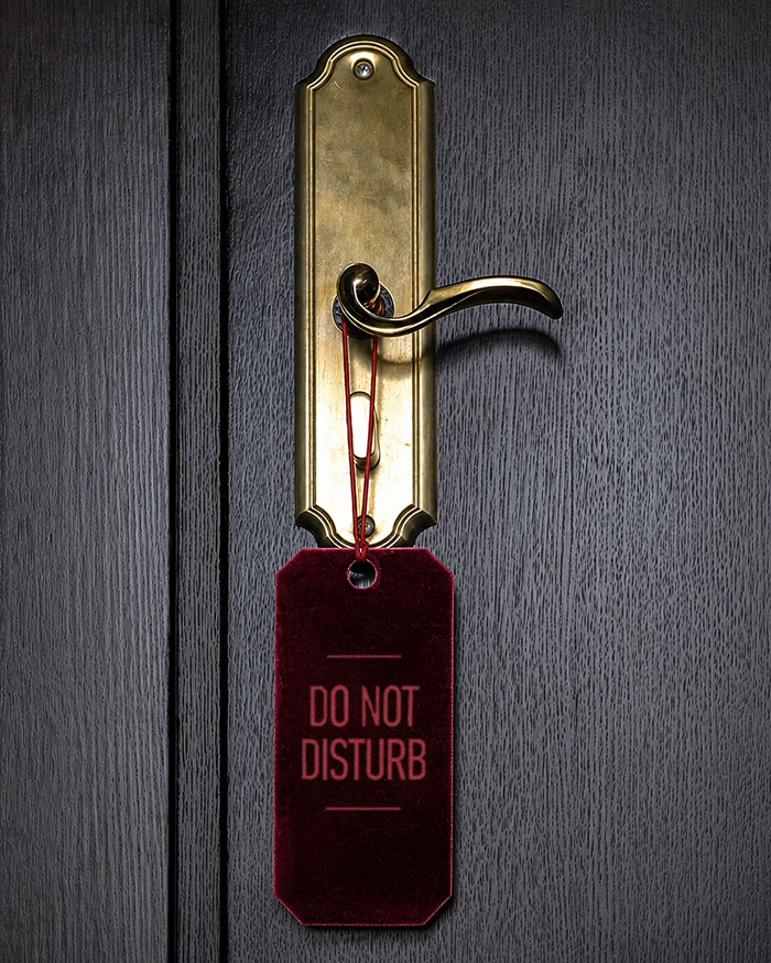 a do not disturb sign hangs on the door as a sign of a successful spice things up candle spell